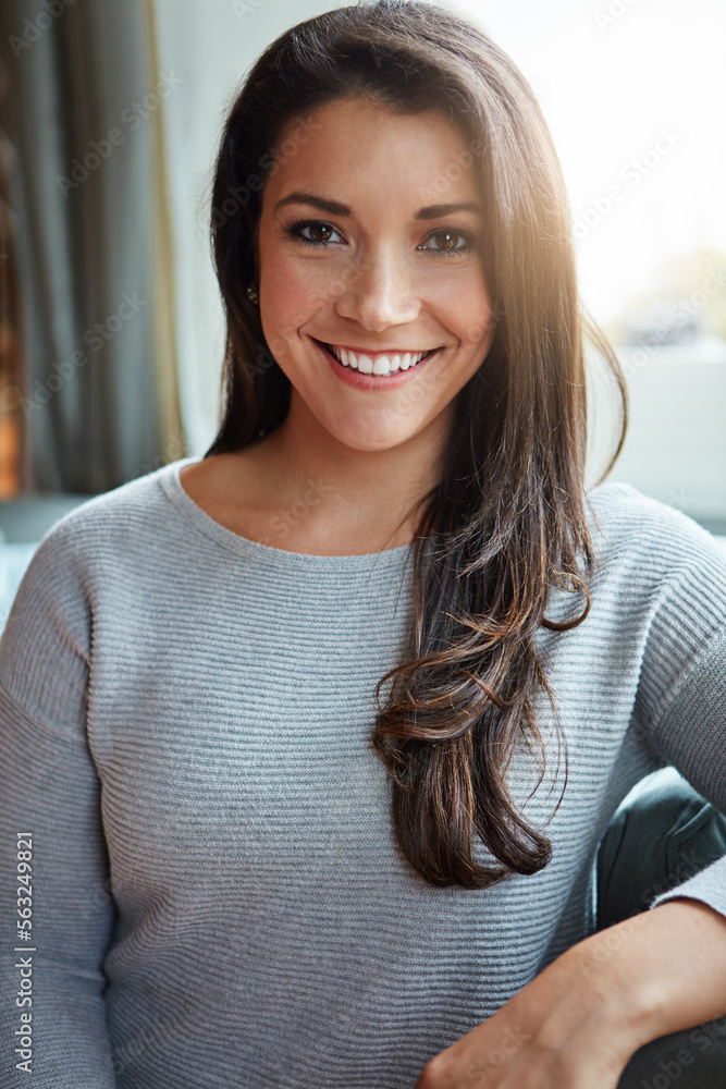 Beauty, woman and smile portrait of a young person on a home sofa in a living room lounge. Female, h