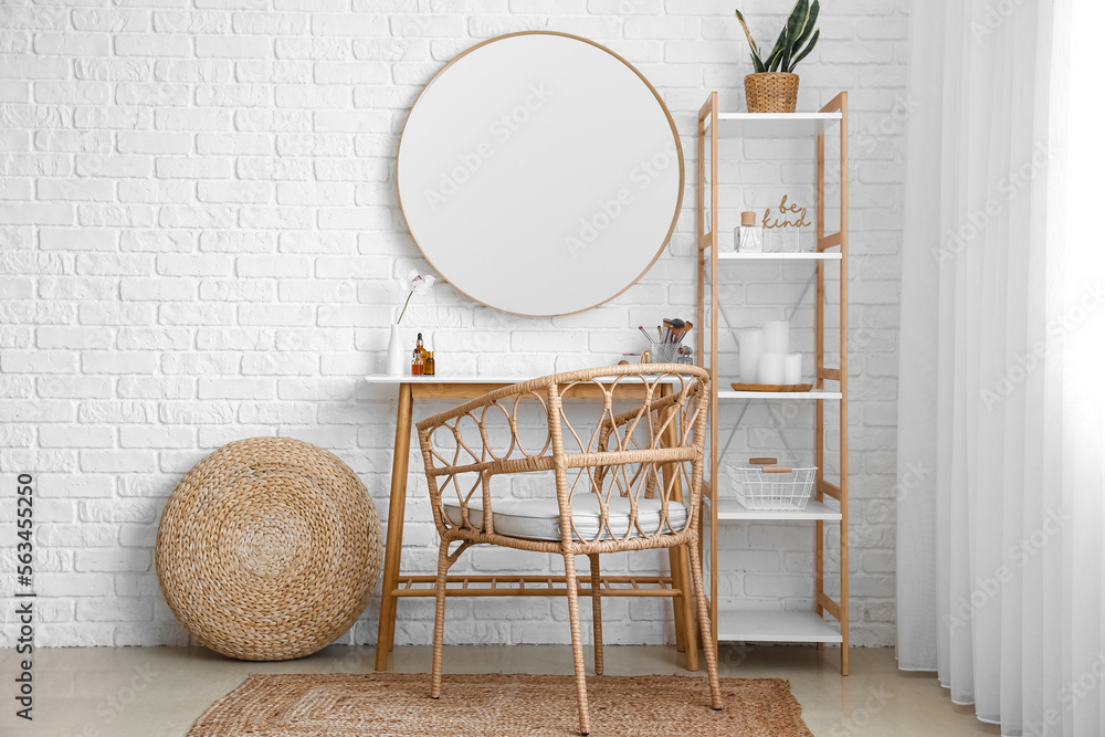 Interior of stylish makeup room with table, mirror and shelving unit