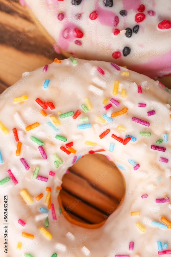 Sweet glazed donuts with sprinkles, closeup