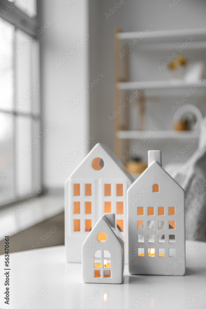 House candle holders on table in light living room, closeup