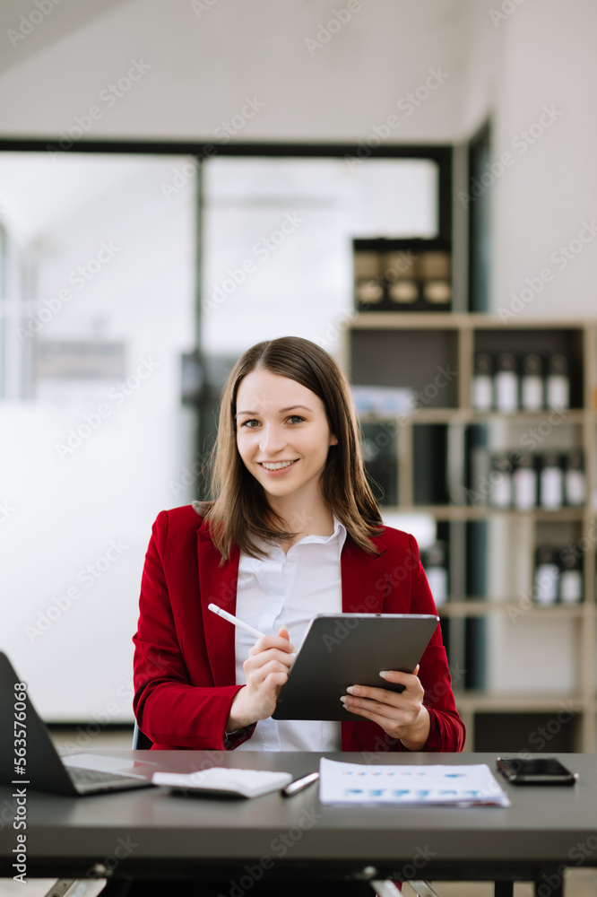 Woman freelancer is working her job on computer tablet and laptop Doing accounting analysis report r