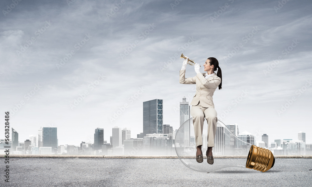 Attractive woman playing trumpet brass