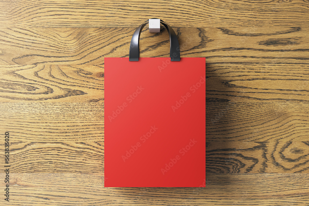 Close up of red shopping or present bag on hanging on wooden backdrop. Mock up, 3D Rendering.