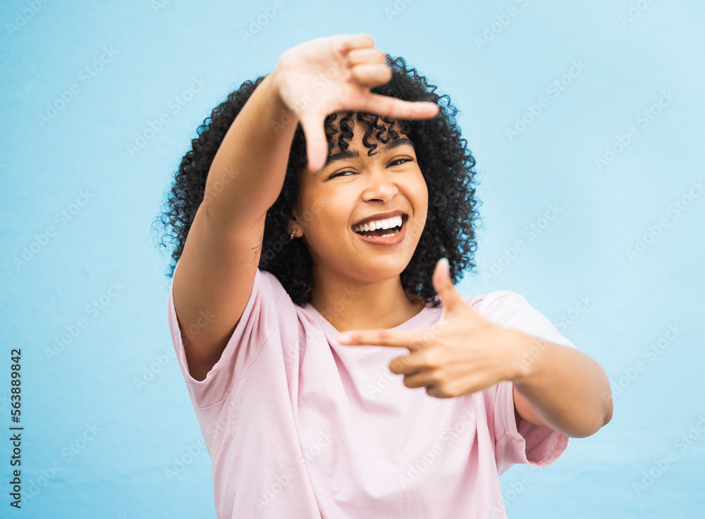 Black woman, hands and smile for frame, picture perfect or photo against a blue studio background. P