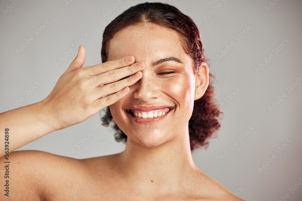 Hand, beauty and woman in studio for makeup, self care and cosmetics, happy and smile on isolated gr