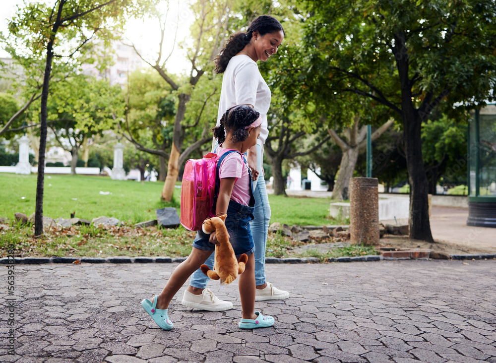 Mother, daughter and walking in a park, relax and bonding while holding hands and talking. Family, b