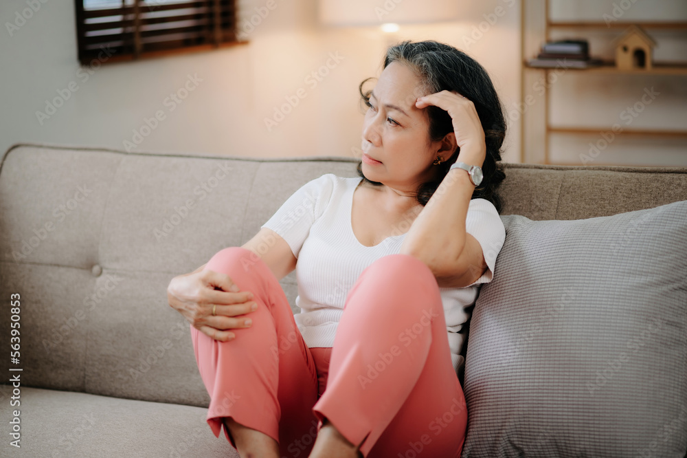 Old asian woman sit Depression Dark haired  pensive glance Standing by window and anxiety Copy space