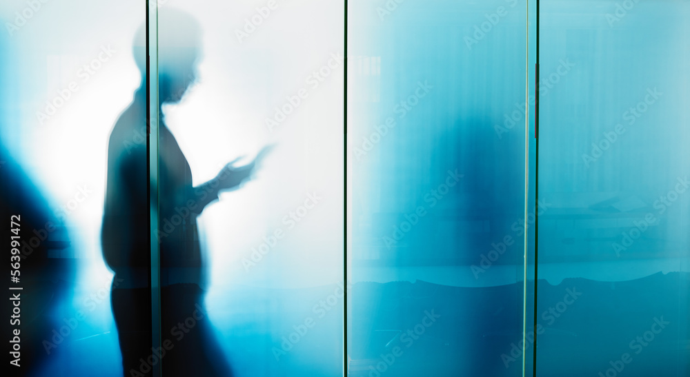 Glass wall, email and businessman reading on a phone for contact, communication and work. Silhouette