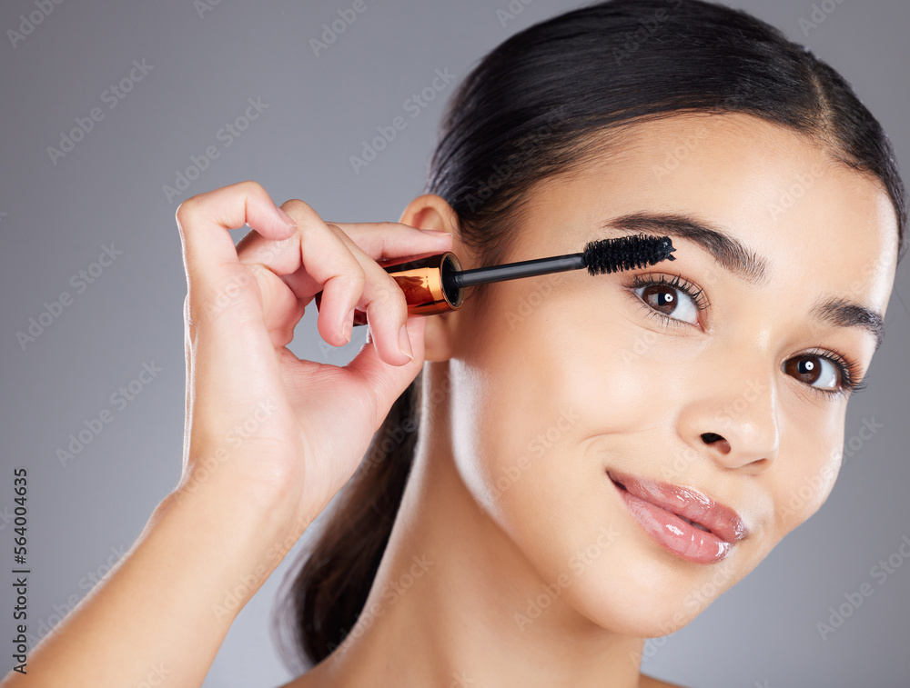 Portrait, eyelash and brush for makeup, mascara and beauty with girl with grey studio background. Fa