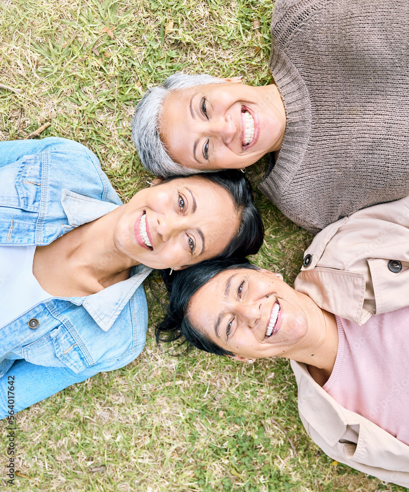 Portrait, family and mother, grandmother and adult daughter relax on grass, happy and bonding in a g