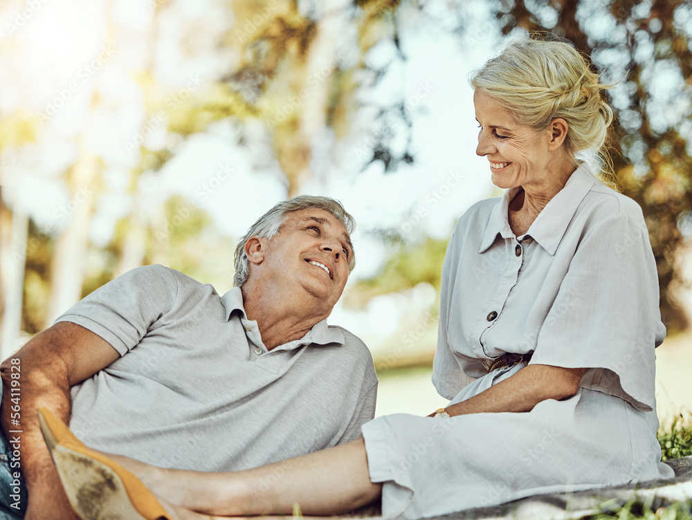 Retirement, love and picnic with a mature couple outdoor in nature to relax on a green field of gras