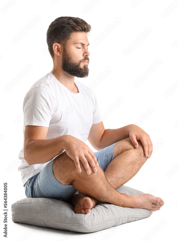 Handsome bearded man meditating on white background