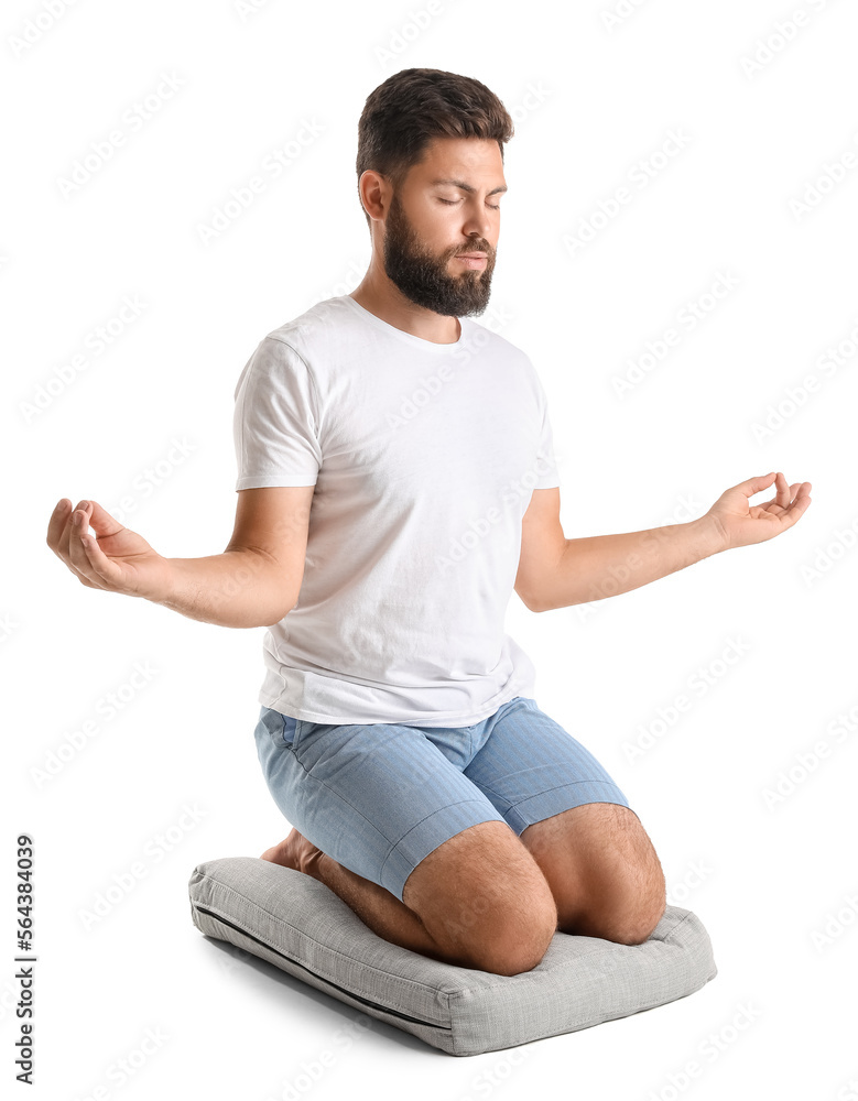 Handsome bearded man meditating on white background