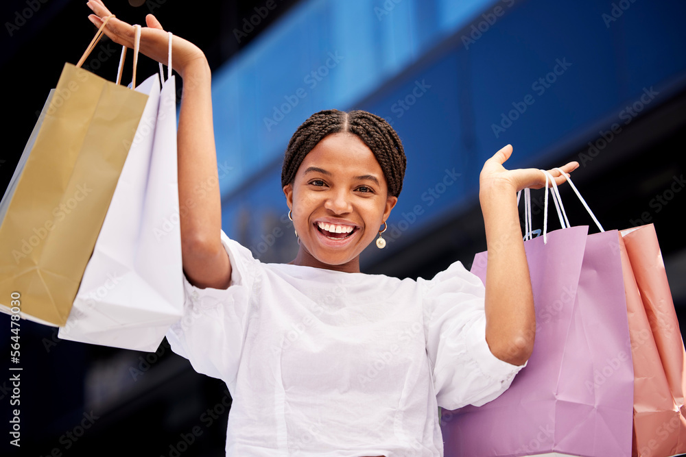 Portrait, shopping and an excited black woman customer carrying bags in a mall for retail or consume