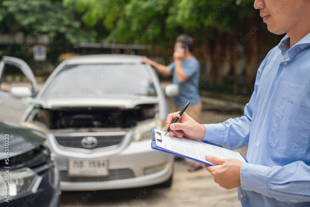 Insurance officer writing Insurance Claim Report on clipboard while insurance. Man and Insurance age