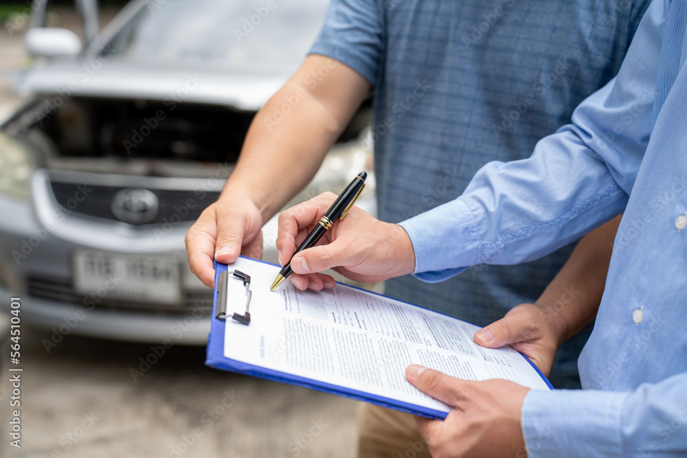 Insurance officer writing Insurance Claim Report on clipboard while insurance. Man and Insurance age