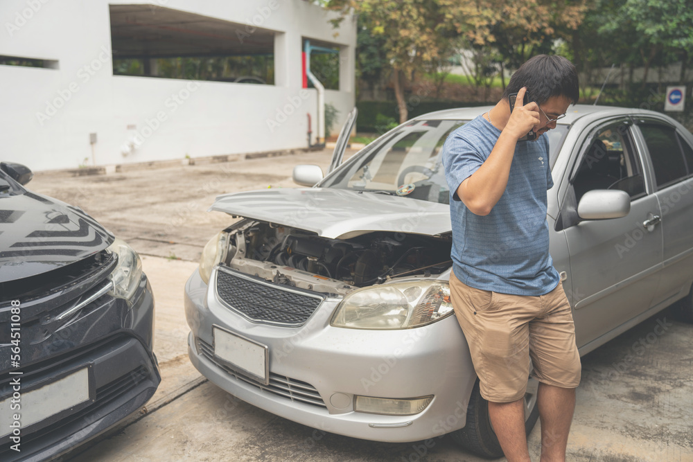 One man reporting car crash damage calling insurance and Claim roadside service