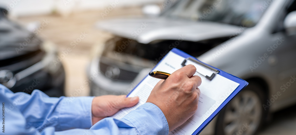 Insurance officer writing Insurance Claim Report on clipboard while insurance. Man and Insurance age