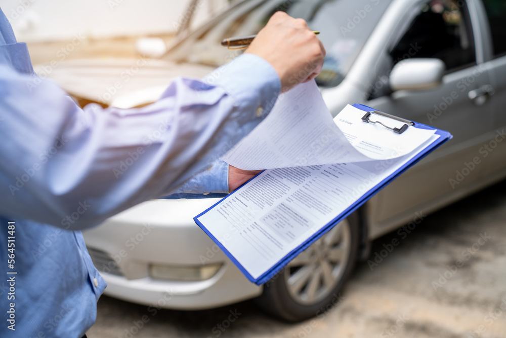 Insurance officer writing Insurance Claim Report on clipboard while insurance. Man and Insurance age