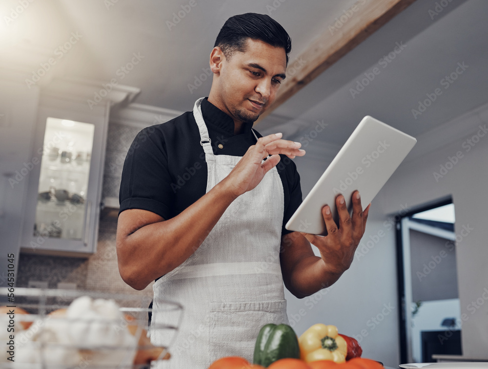 Man, cooking vegetables and tablet in kitchen while online with house wifi connection for learning o