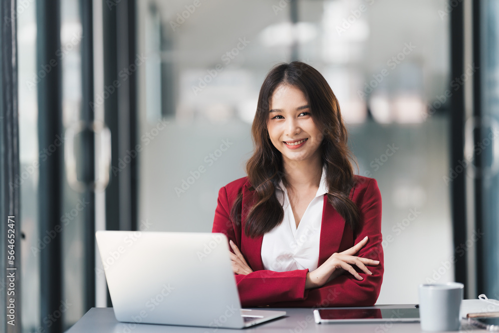 Young beautiful businesswoman working on her project in modern office room.