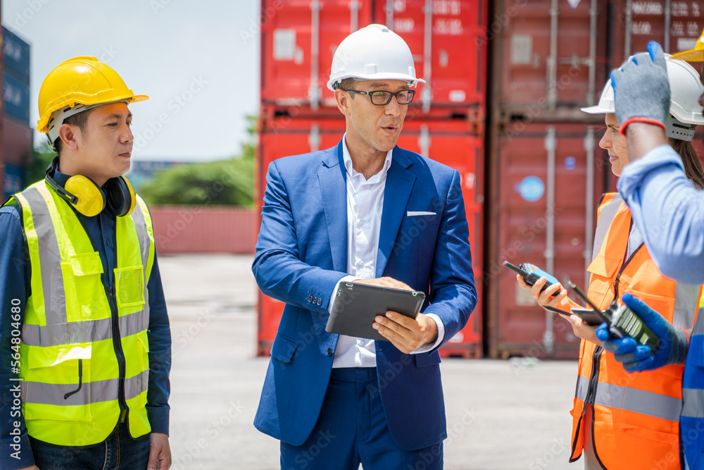 Businessman and engineer or Foreman checking the container to prepare the delivery to the customer.