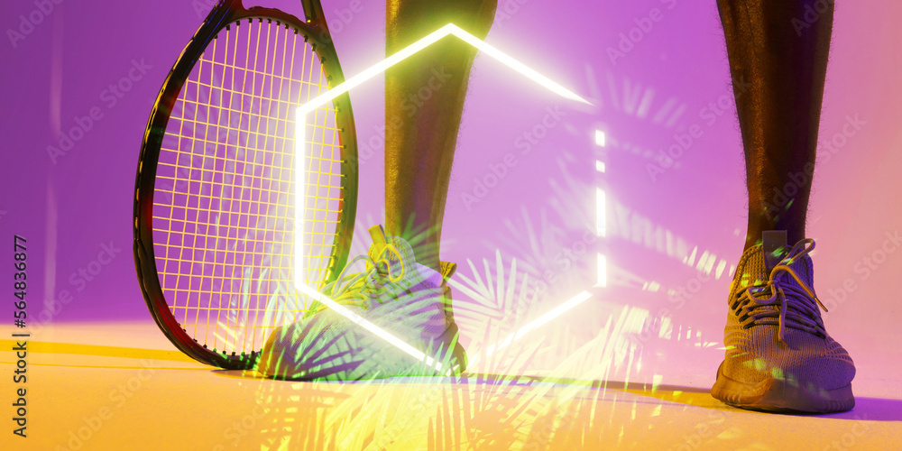 Low section of african american male player with tennis racket over illuminated plants and hexagon