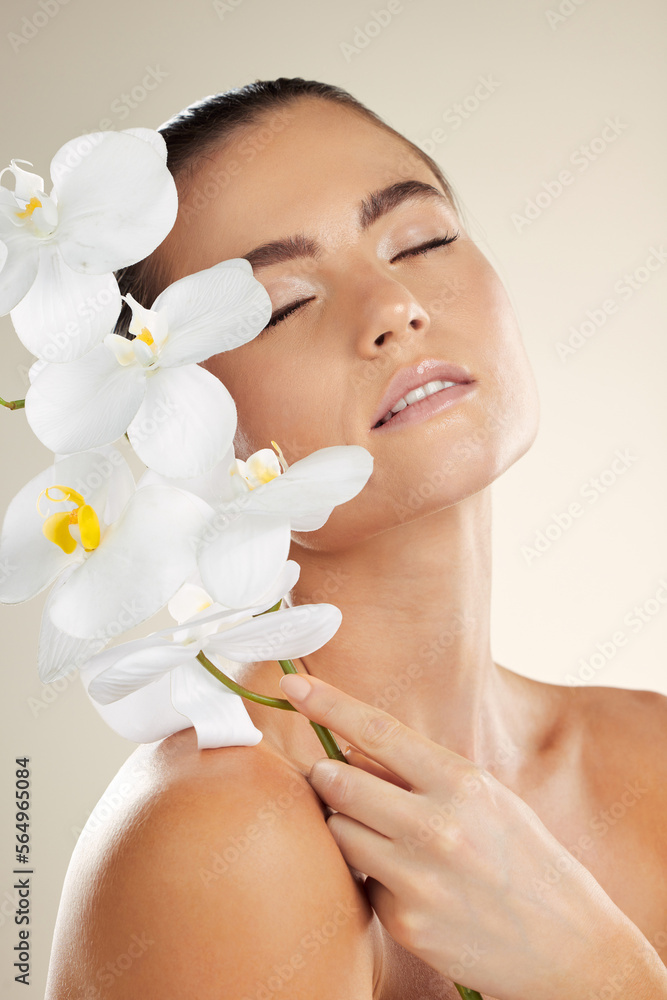 Skincare, beauty and woman with orchid flower on skin for natural dermatology cosmetic product. Glow