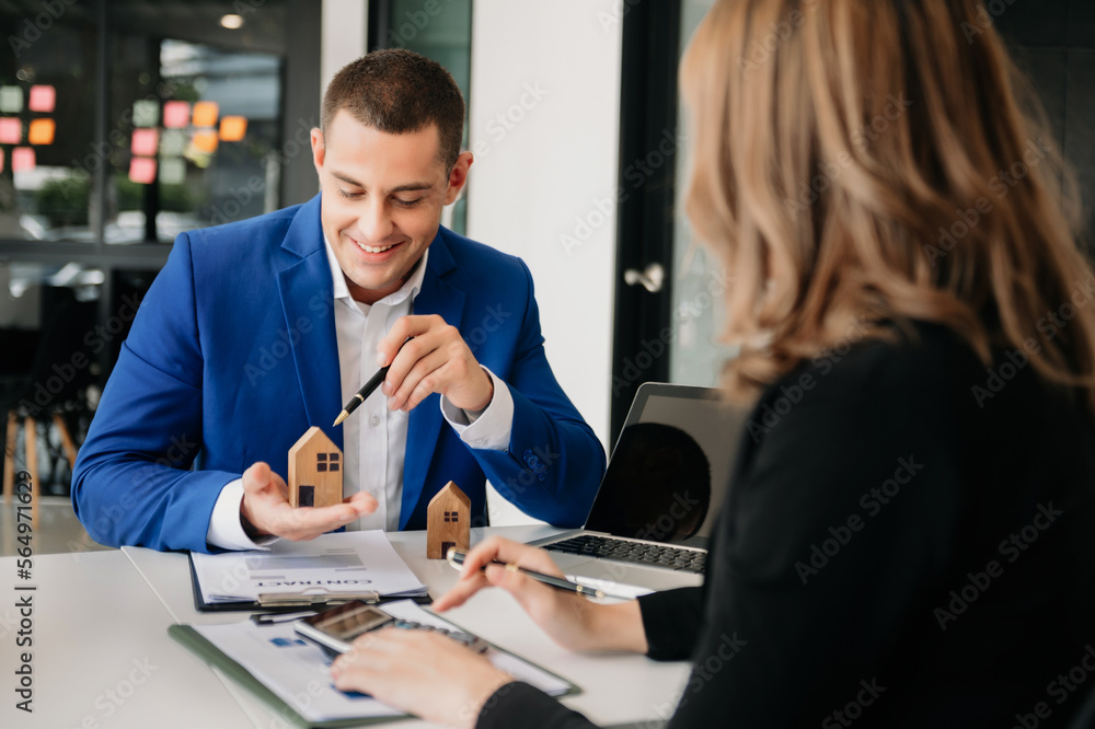 uying a home or insurance deal, an insurance agent pointing a pen to those interested in renting a h