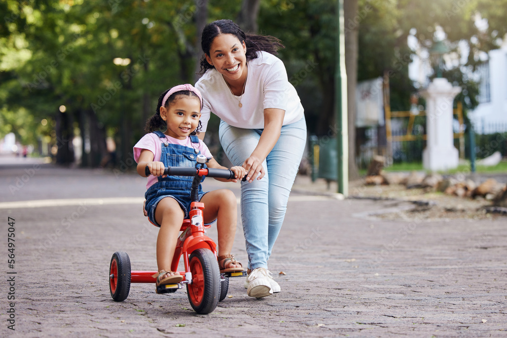 Mother, kid and bicycle teaching with training wheels for learning, practice or safety at the park. 