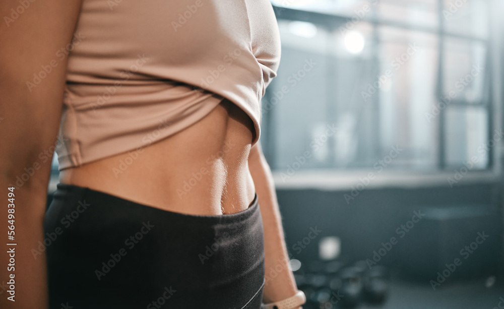 Fitness, stomach and woman in a gym for exercise, health or wellness for weightloss training. Sports