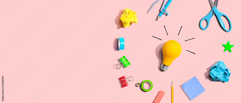 Idea light bulb with school supplies overhead view - flat lay