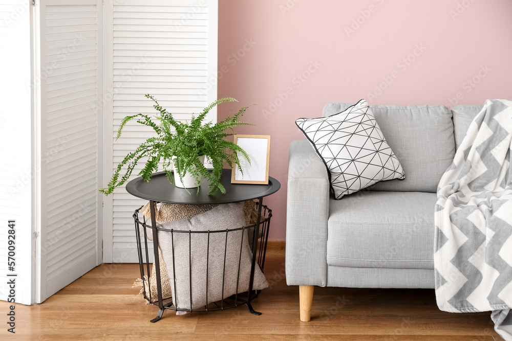 Interior of stylish living room with grey sofa and table