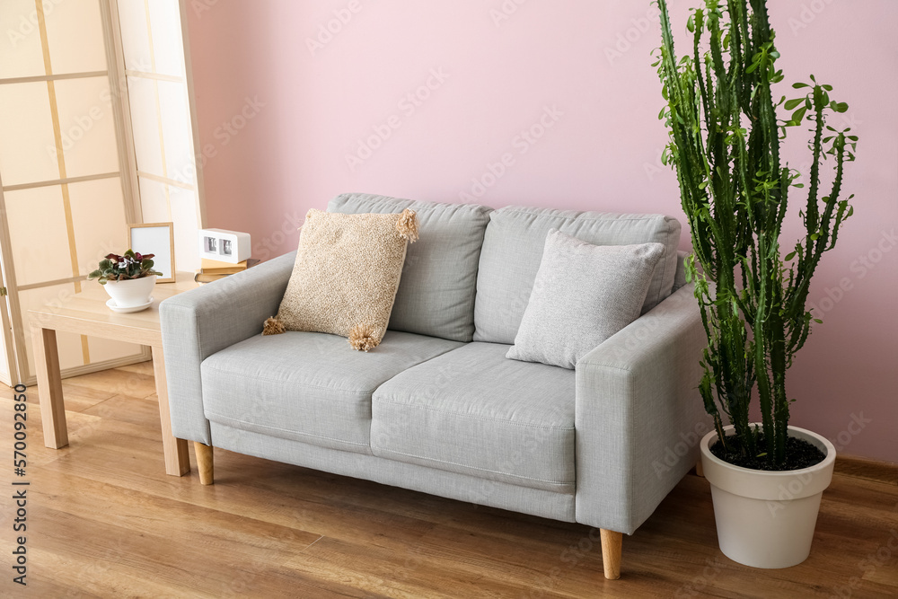 Interior of stylish living room with grey sofa and table