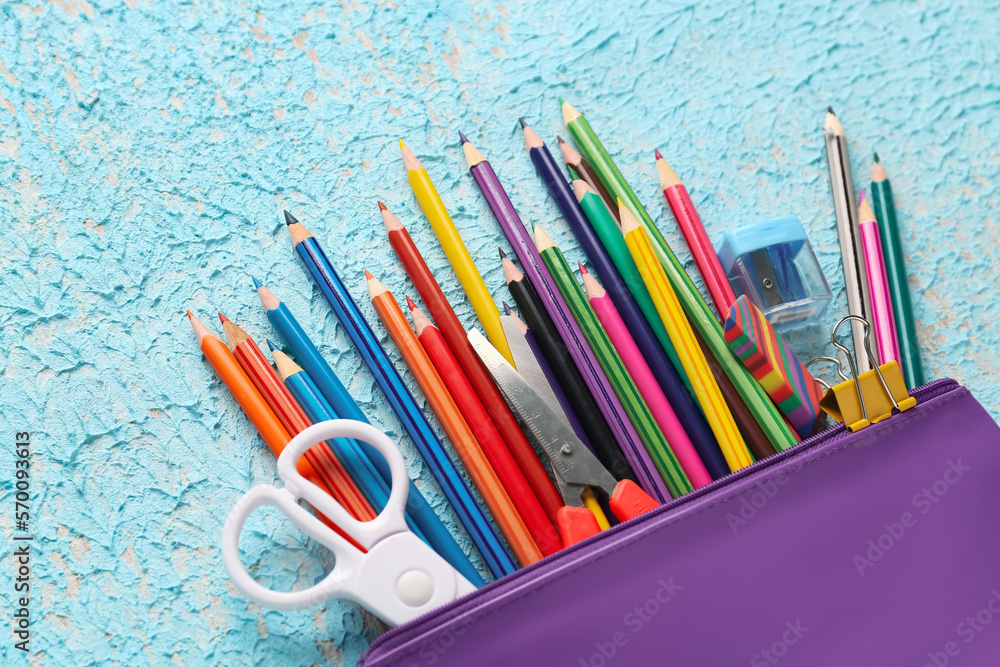 Case with pencils, scissors, eraser and sharpener on color background, closeup