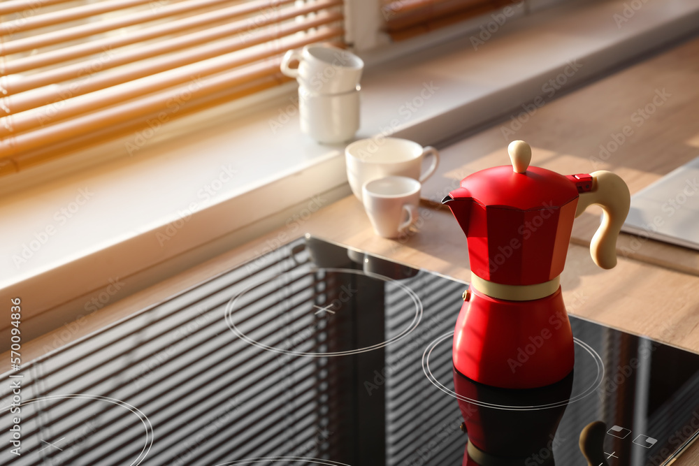 Geyser coffee maker on electric stove in kitchen