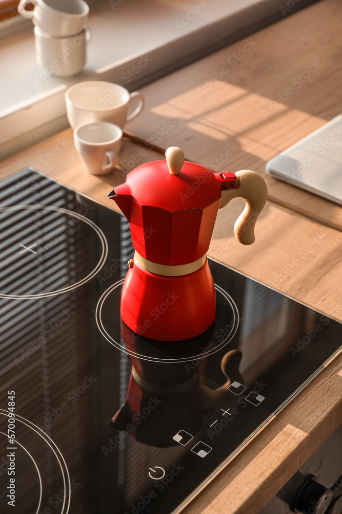 Geyser coffee maker on electric stove in kitchen