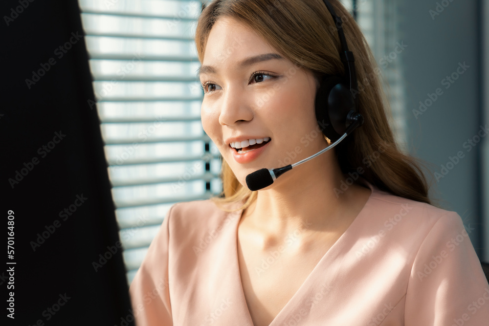 Competent female operator working on computer and while talking with clients. Concept relevant to bo