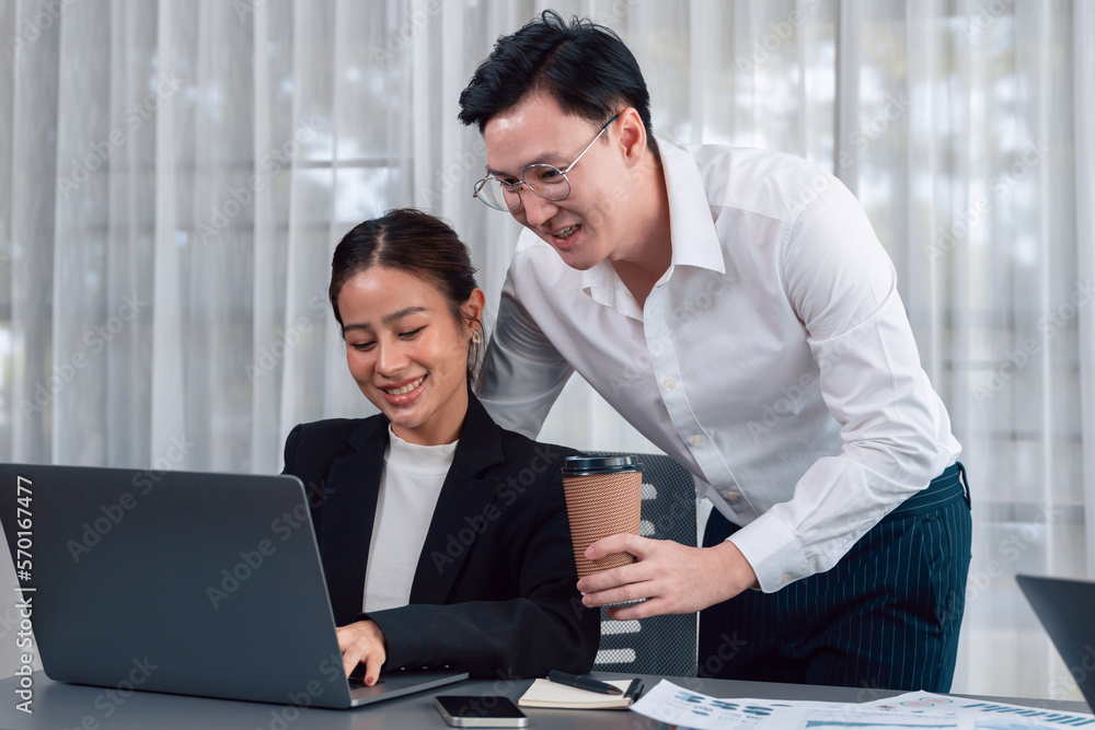 Mentor, manager with coffee advice younger colleagues in workplace. Couple businesspeople discussing