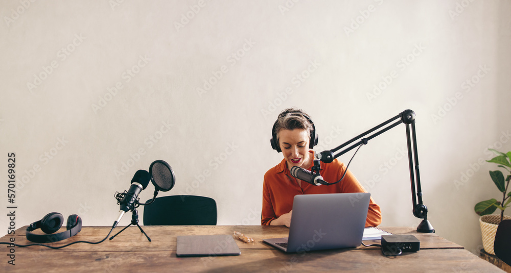 Female radio dj preparing a show in a studio