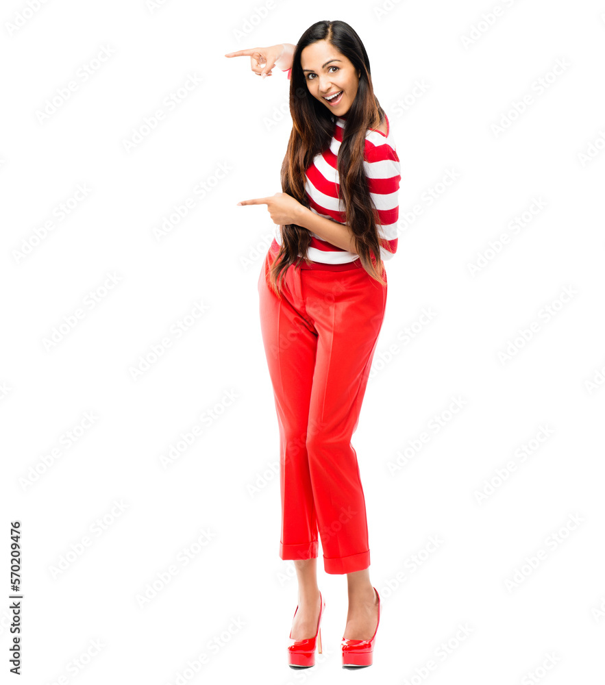 A cheerful gorgeous young girl in a red strapped T-shirt pointing at a copy space on the right side 