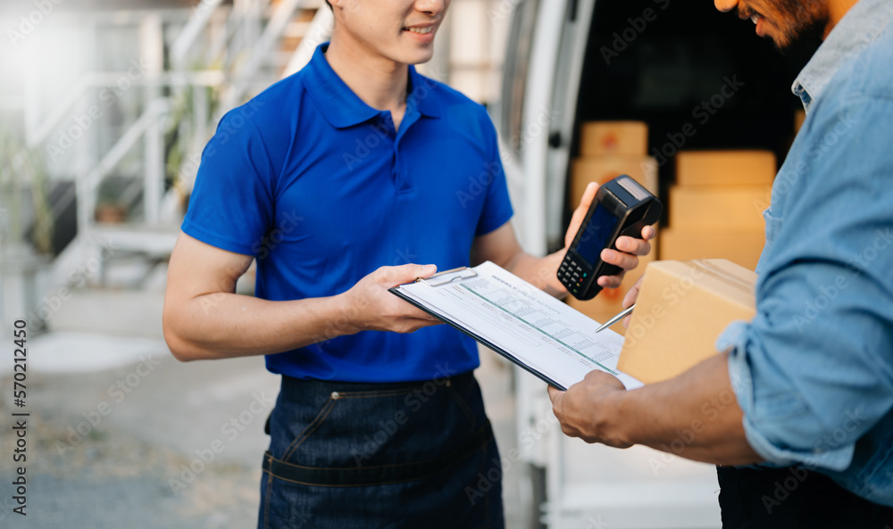 Parcel delivery and a name tag is delivering parcels to a client. Friendly worker, high quality deli