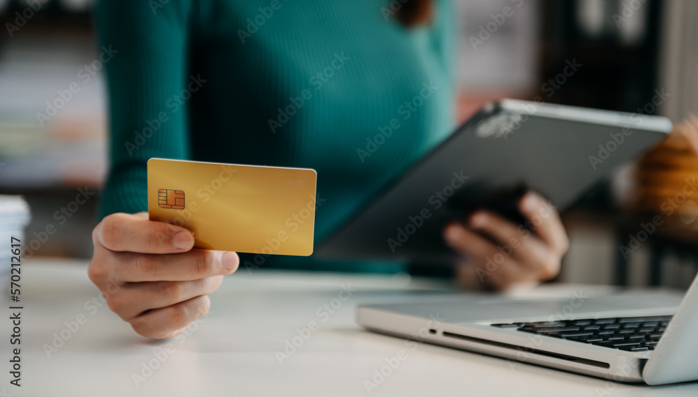 Woman using smart phone for mobile payments online shopping,omni channel,sitting on table,virtual ic