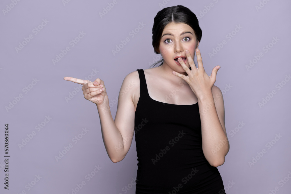 Young charming caucasian teenager girl with clean and fresh skin posing pointing fingers on empty ba