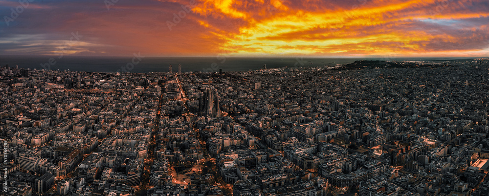 Aerial view of Barcelona City Skyline and Sagrada Familia Cathedral at sunset. Eixample residential 