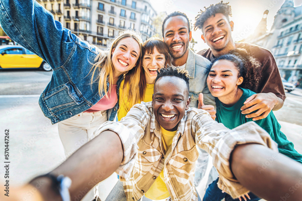 Multiracial best friends taking selfie walking on city street - Happy young people having fun enjoyi