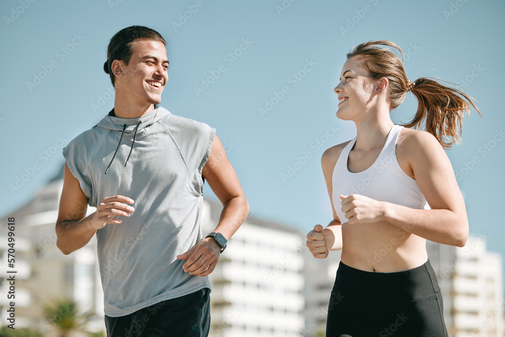 Couple, fitness and smile running in the city for exercise, workout or cardio routine together in Ca