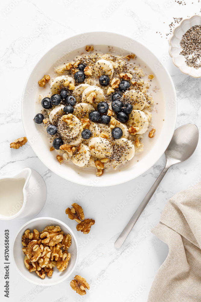 Oatmeal bowl. Oat porridge with banana, blueberry, walnut, chia seeds and oat milk for healthy break