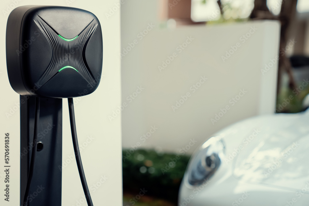 Focus electric home charging station powered from green energy at home for vehicle engine. Progressi