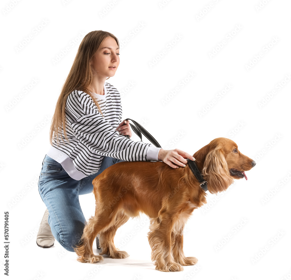 Young woman with red cocker spaniel on white background